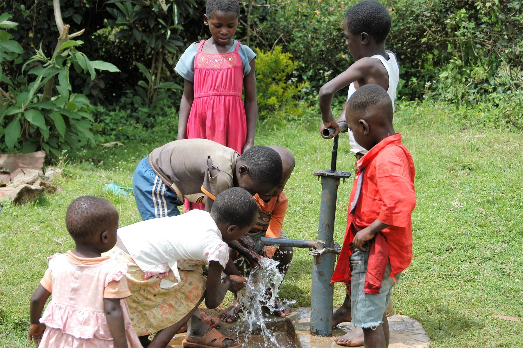 Kids getting water in Kenya, eco-friendly sandals, shoes, and slippers, Freewaters